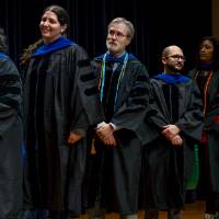 Faculty lined up on stage
